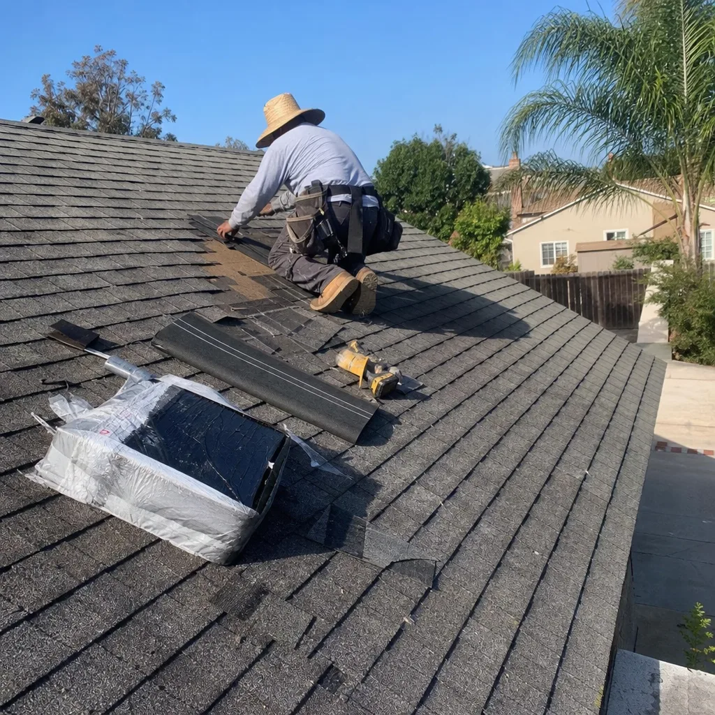 Professional contractor performing residential roof repair and shingle replacement